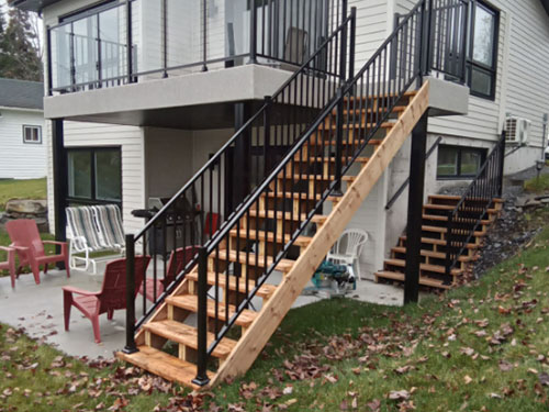 Une terrasse avec des escaliers menant à une maison.